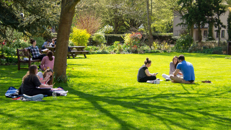 Students sit in the Sundial Garden