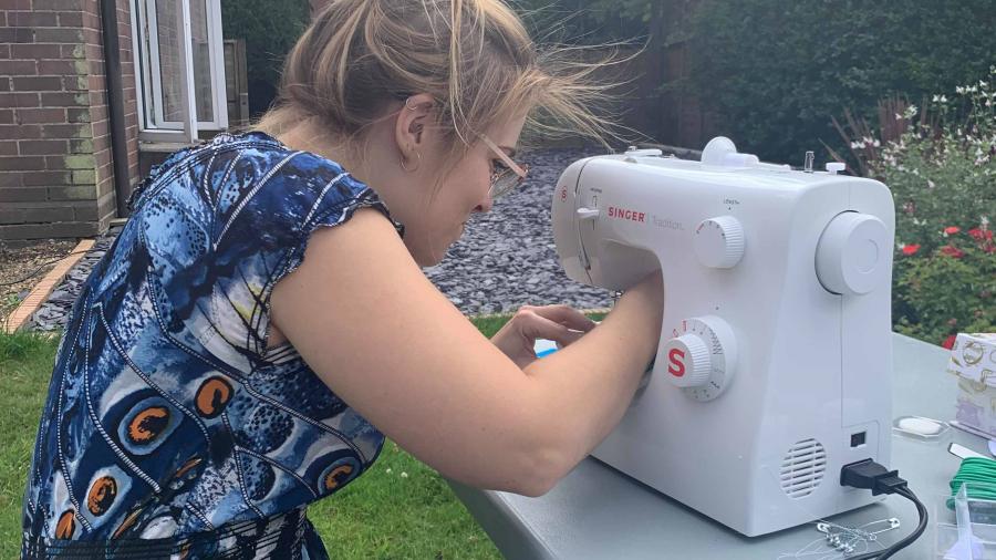 A picture of a Wolfson student using the Green Society sewing machine