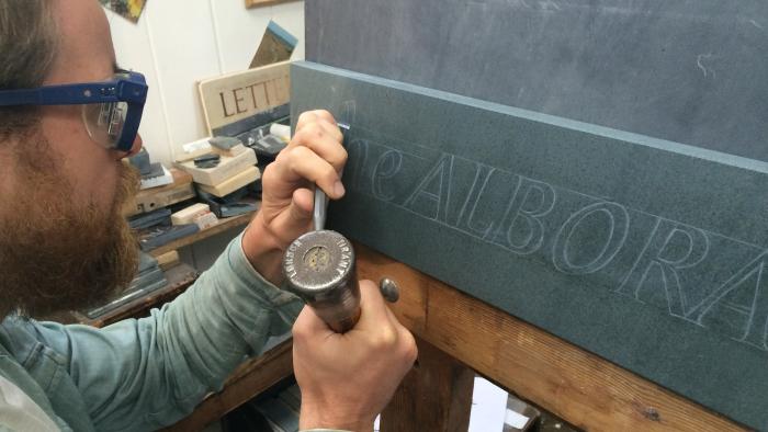 Carving the Alborada slate sign