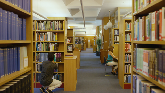 A student looks for books in the College Library