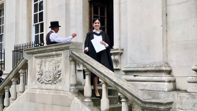 Mashal descends the steps outside the Senate-House with her degree certificate