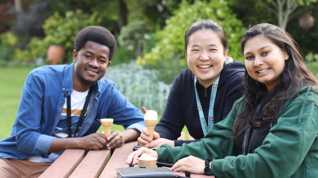 Wolfson students sit outside with ice creams in the sundial garden
