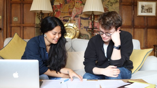 Two students work together on an essay in the Old Combination Room