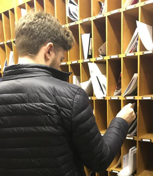Student checking his pigeonhole for mail