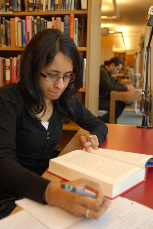 Student studying from a book in Wolfson Libary