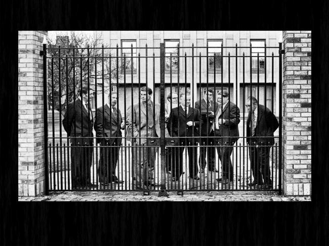 Jack King, Bill Kirkman, Horace Northern and others wait behind the College gates