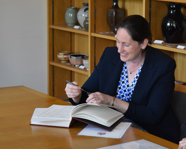 Professor Anna Hollis signs the Fellows Book