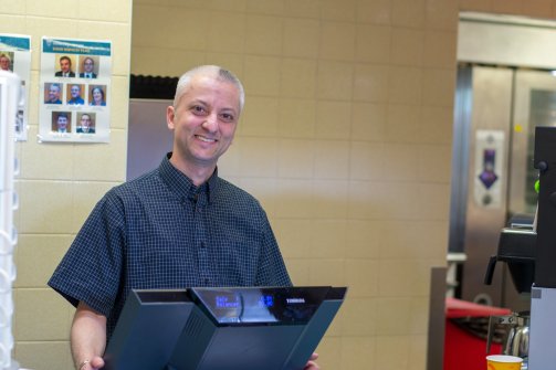 Server in the cafeteria with a big smile by Fiona Gilsenan