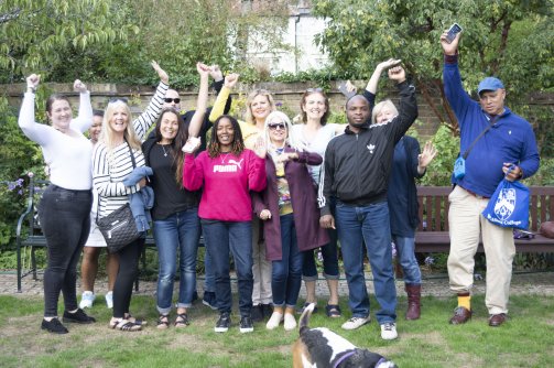 Students and Staff from the Open Book Project celebrate their time at Wolfson College (30 August 2018). From left to right: Kelly, Michelle, Carolyn, Sarah, James, Tracie, Jennifer, Susan, Fiona, Jerry, Judith, David. Foreground: Banjo.