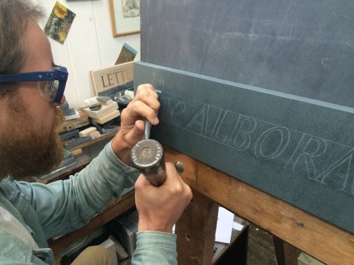 Carving the Alborada slate sign