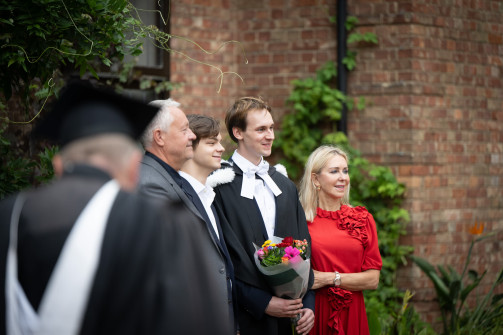Graduates and family pose for photos at Wolfson