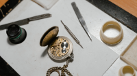 A photo of a pocket watch open for repair